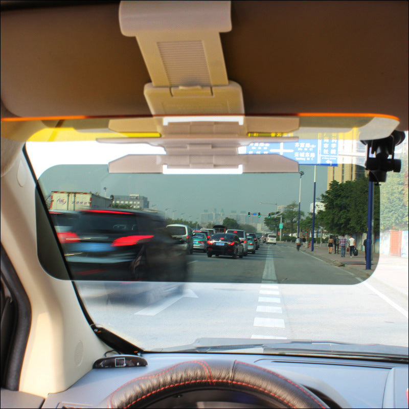 Anti-glare car sun visor flipped down behind the windscreen, seen from the driver's seat