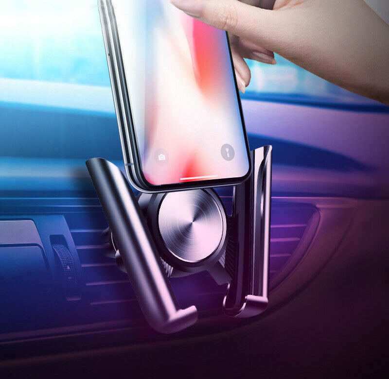 A phone held in the vent mount on a car dashboard