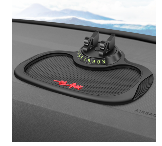 GripPad non-slip mat and parking card sitting on a car dashboard with the phone bracket fitted