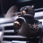 Aviator bear air freshener clipped onto a car air vent with its propeller spinning