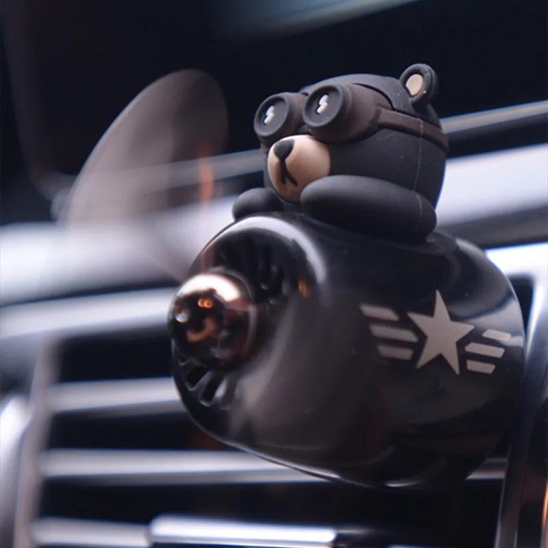 Aviator bear air freshener clipped onto a car air vent with its propeller spinning