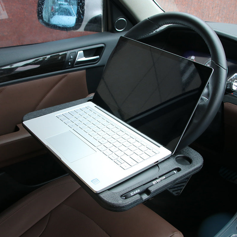 DeskLoop tray holding a laptop in the driver seat