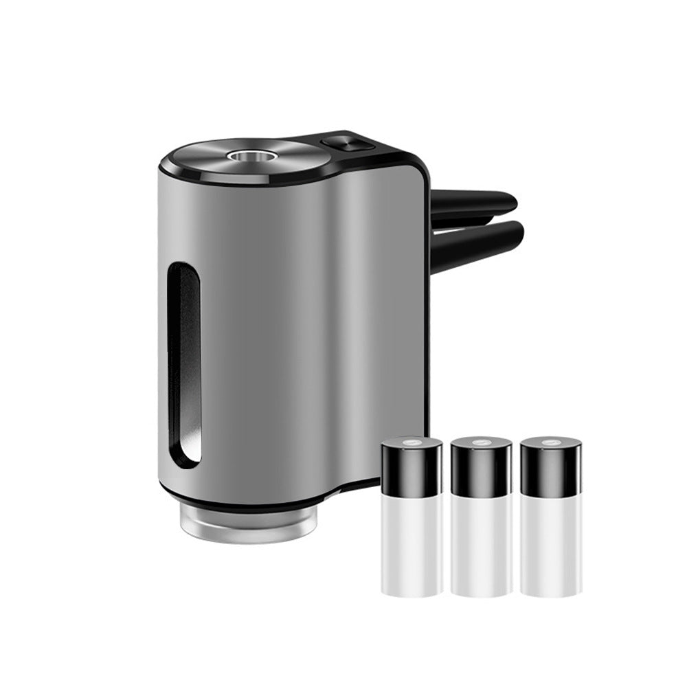 AromaDrive smart car diffuser in silver, with three essential oil bottles