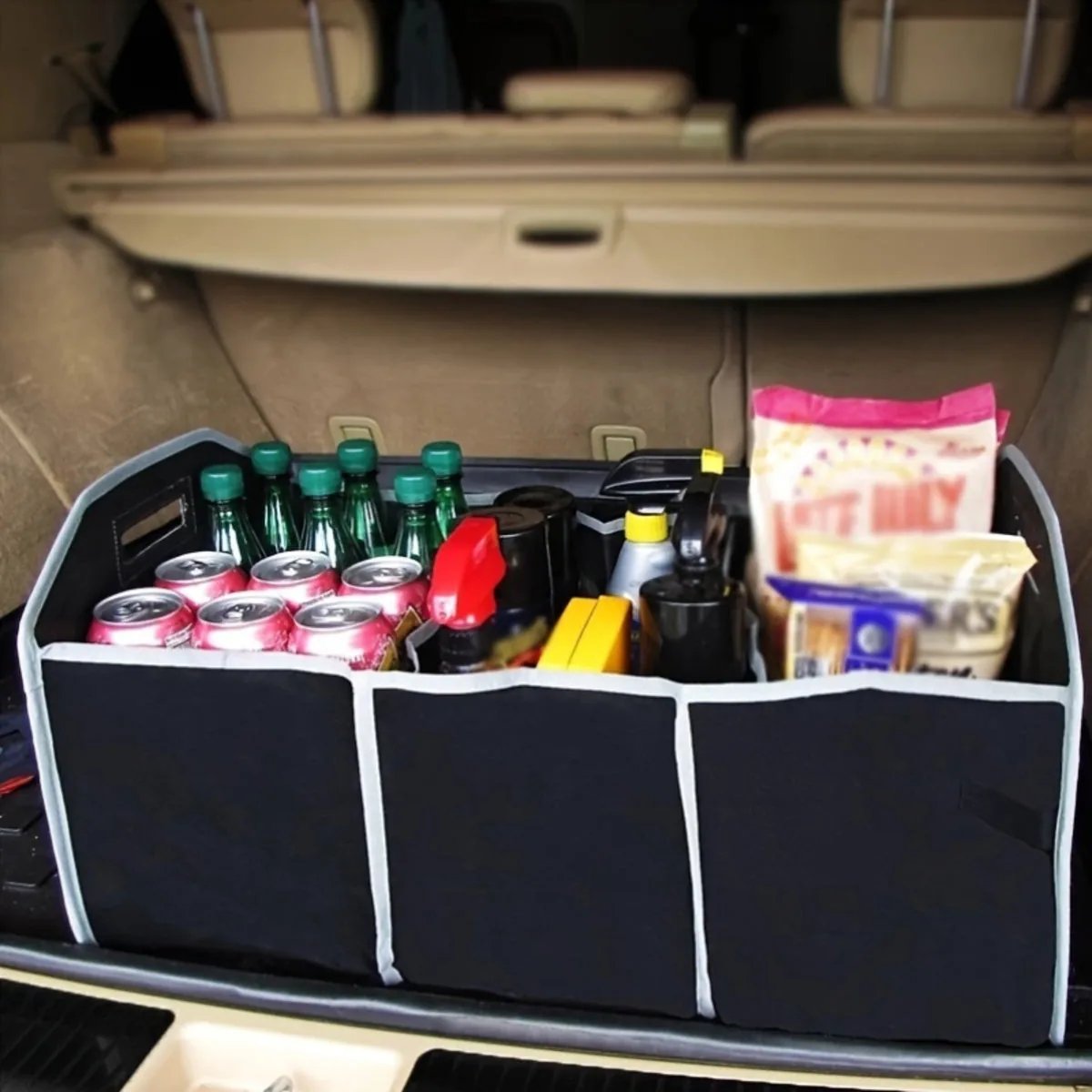 Three-compartment collapsible trunk organizer loaded with groceries and drinks in the boot of a car