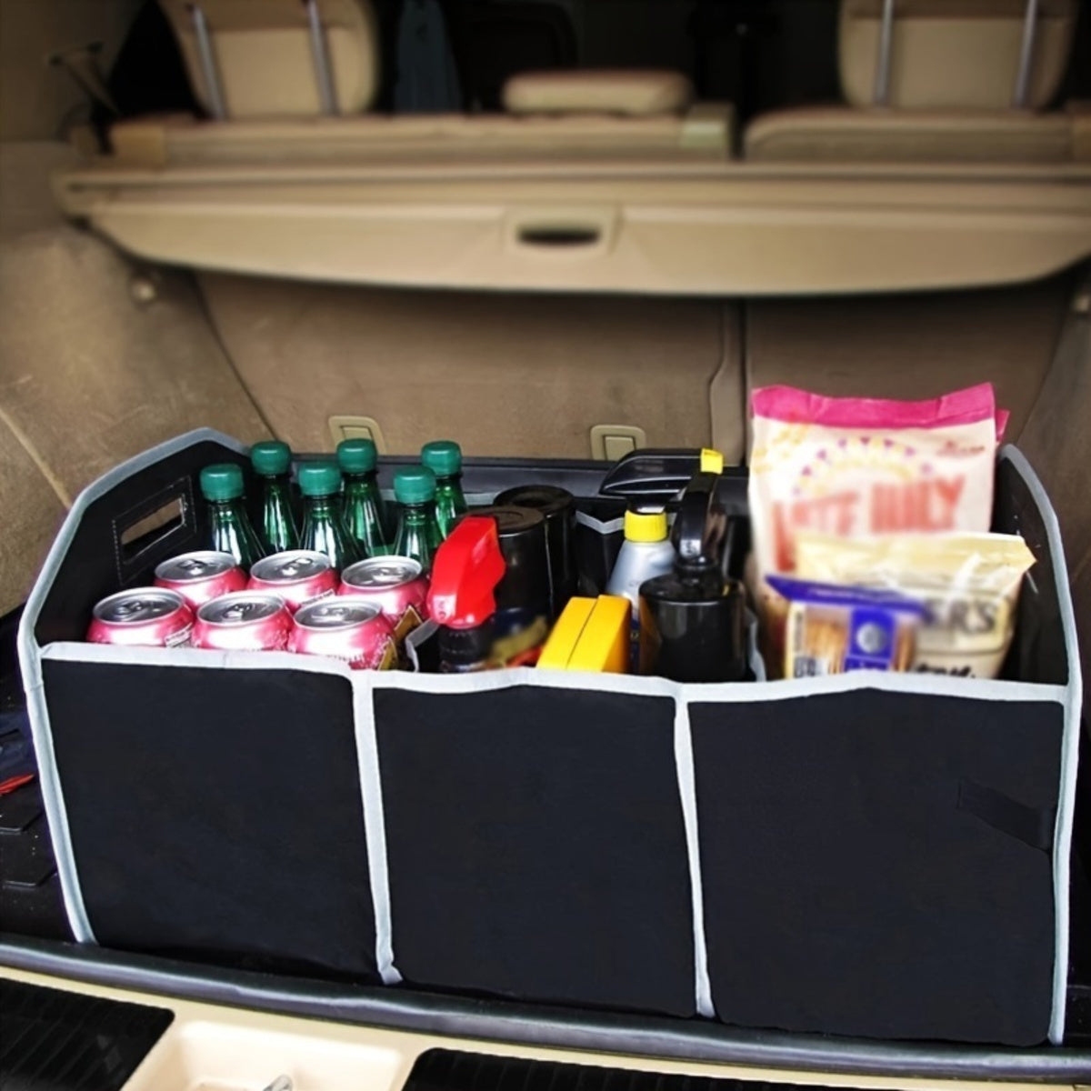 Three-compartment collapsible trunk organizer loaded with groceries and drinks in the boot of a car