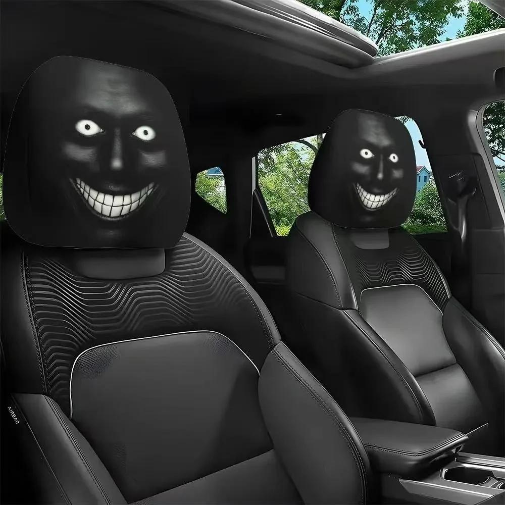 Two grinning creepy-face headrest covers fitted on the front seats of a car interior with sunroof