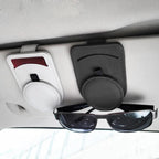 Leather visor clips mounted on a car sun visor holding sunglasses and a card
