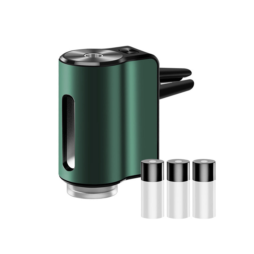 AromaDrive smart car diffuser in dark green, with three essential oil bottles
