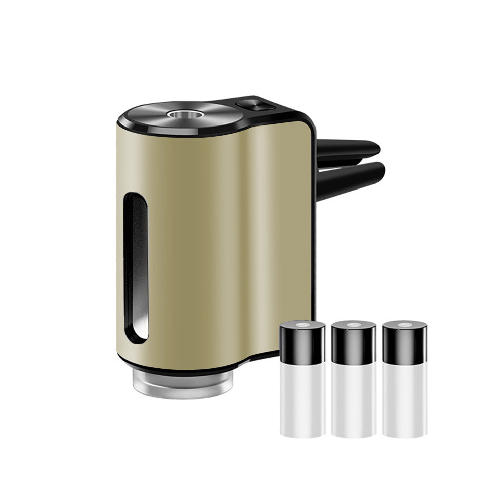 AromaDrive smart car diffuser in champagne gold, with three essential oil bottles