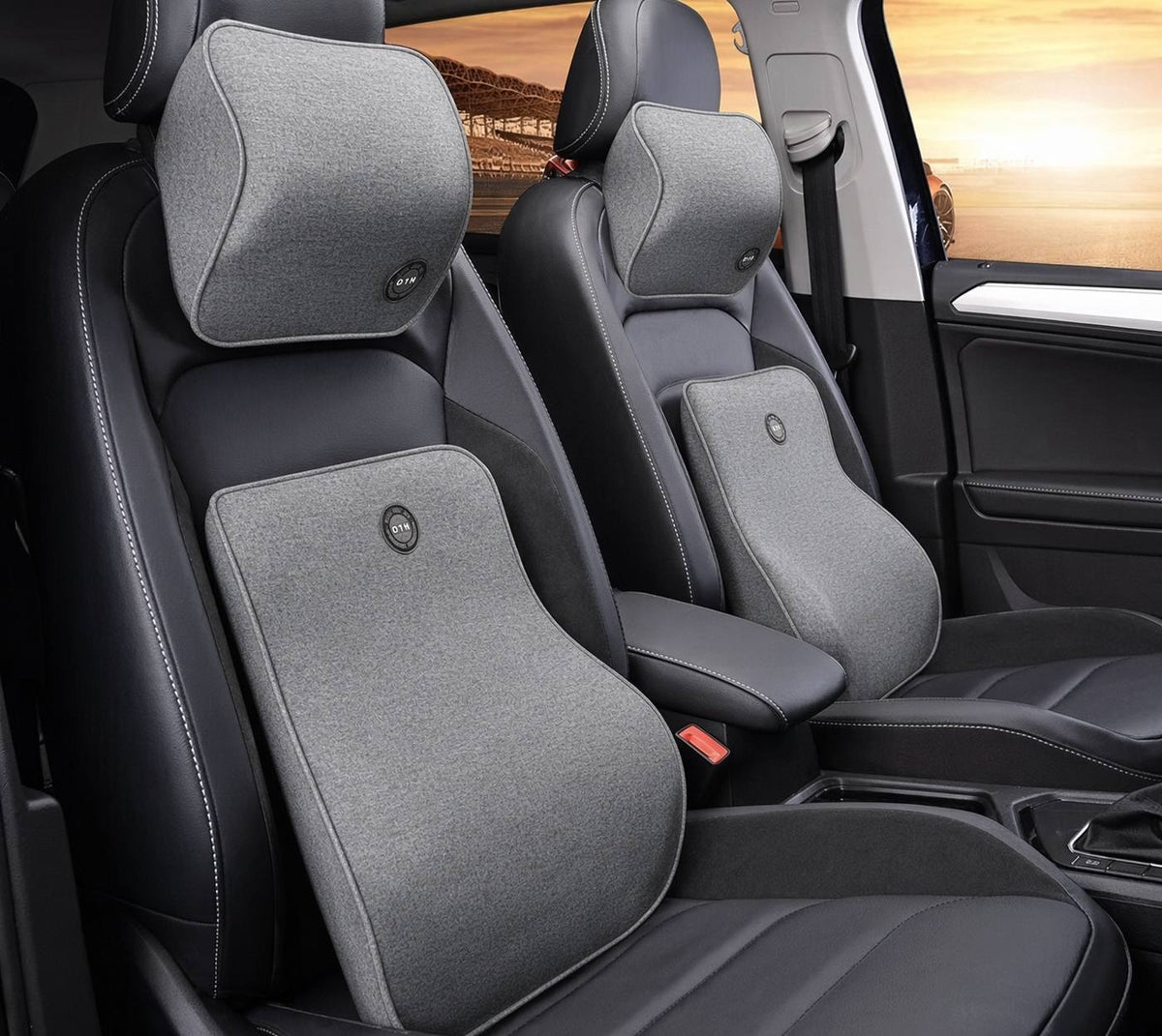 Grey memory foam car headrest and lumbar support pillow set installed in a car