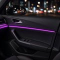 Fiber optic ambient light glowing purple along a car door panel at night