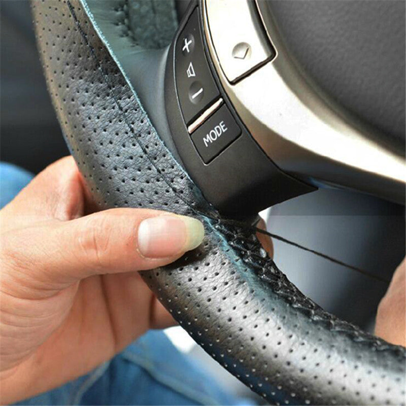 Perforated anti-slip grip detail on the genuine leather wheel cover