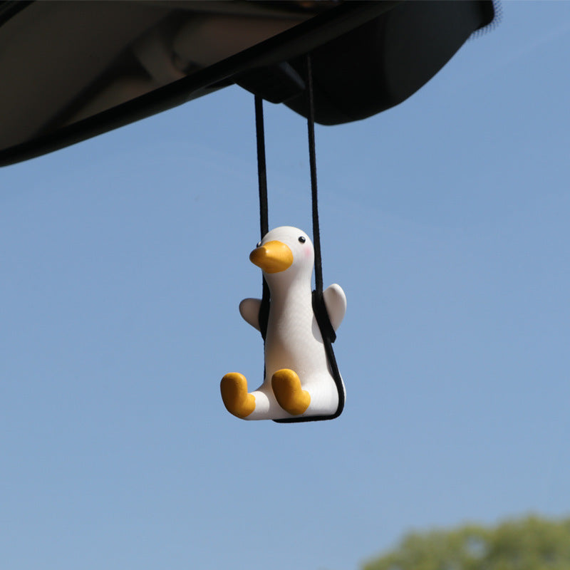 SwingDuck rubber duck charm hanging from a rearview mirror