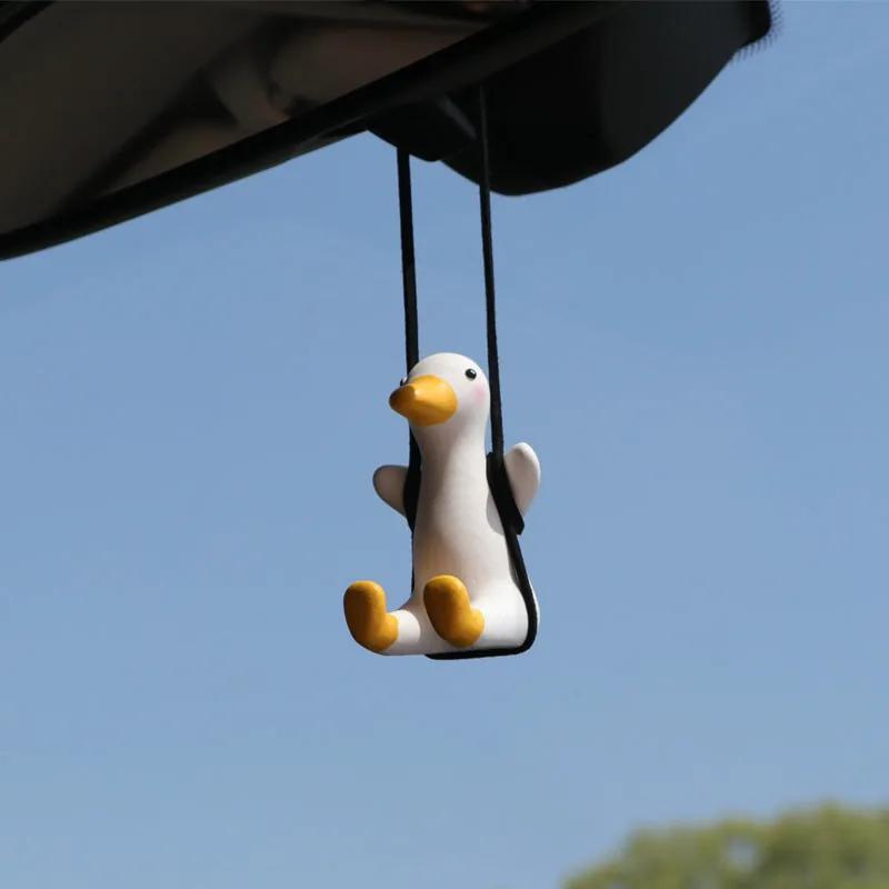 SwingDuck rubber duck charm hanging from a rearview mirror