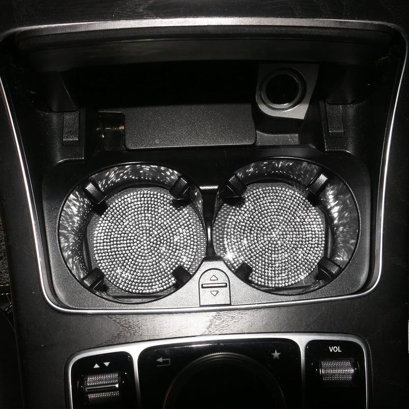Silver crystal coasters in a car's centre-console cup holders