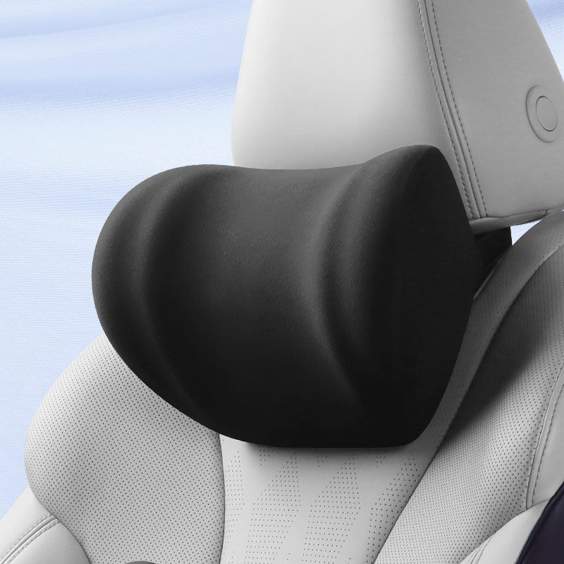 Memory foam car neck pillow strapped to a car headrest