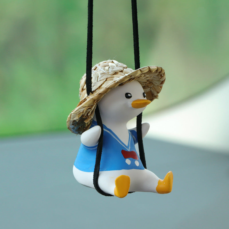 SwingDuck rearview mirror charm — duck in a blue straw hat