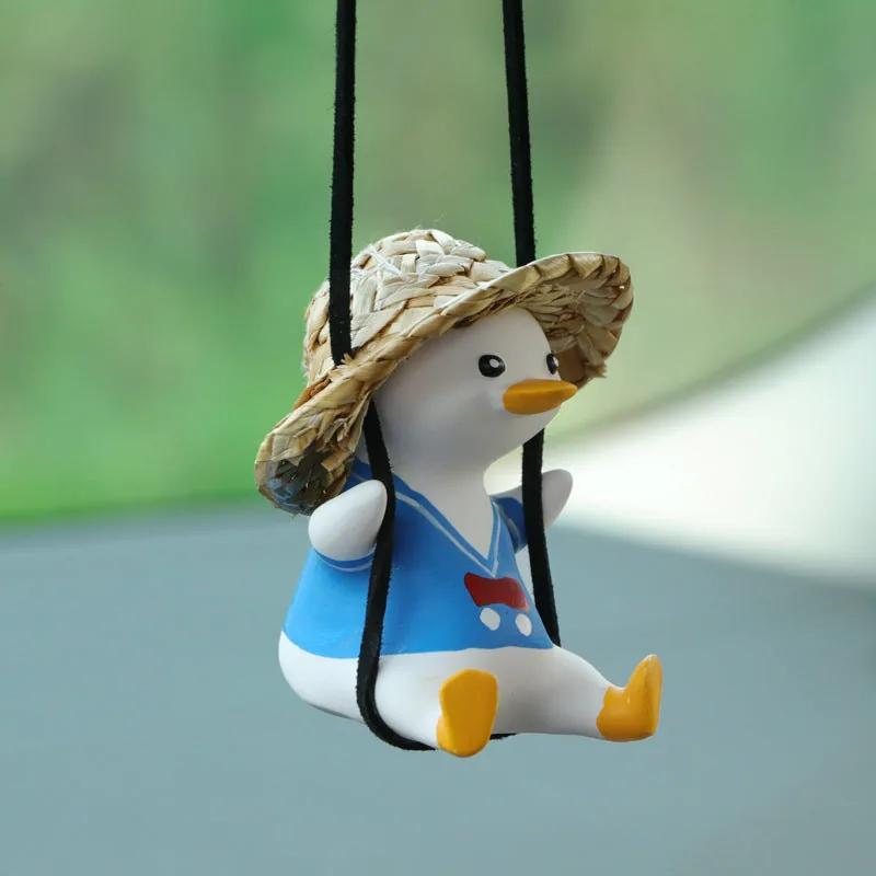 SwingDuck rearview mirror charm — duck in a blue straw hat