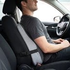 Memory foam car lumbar support cushion strapped to a car seat back