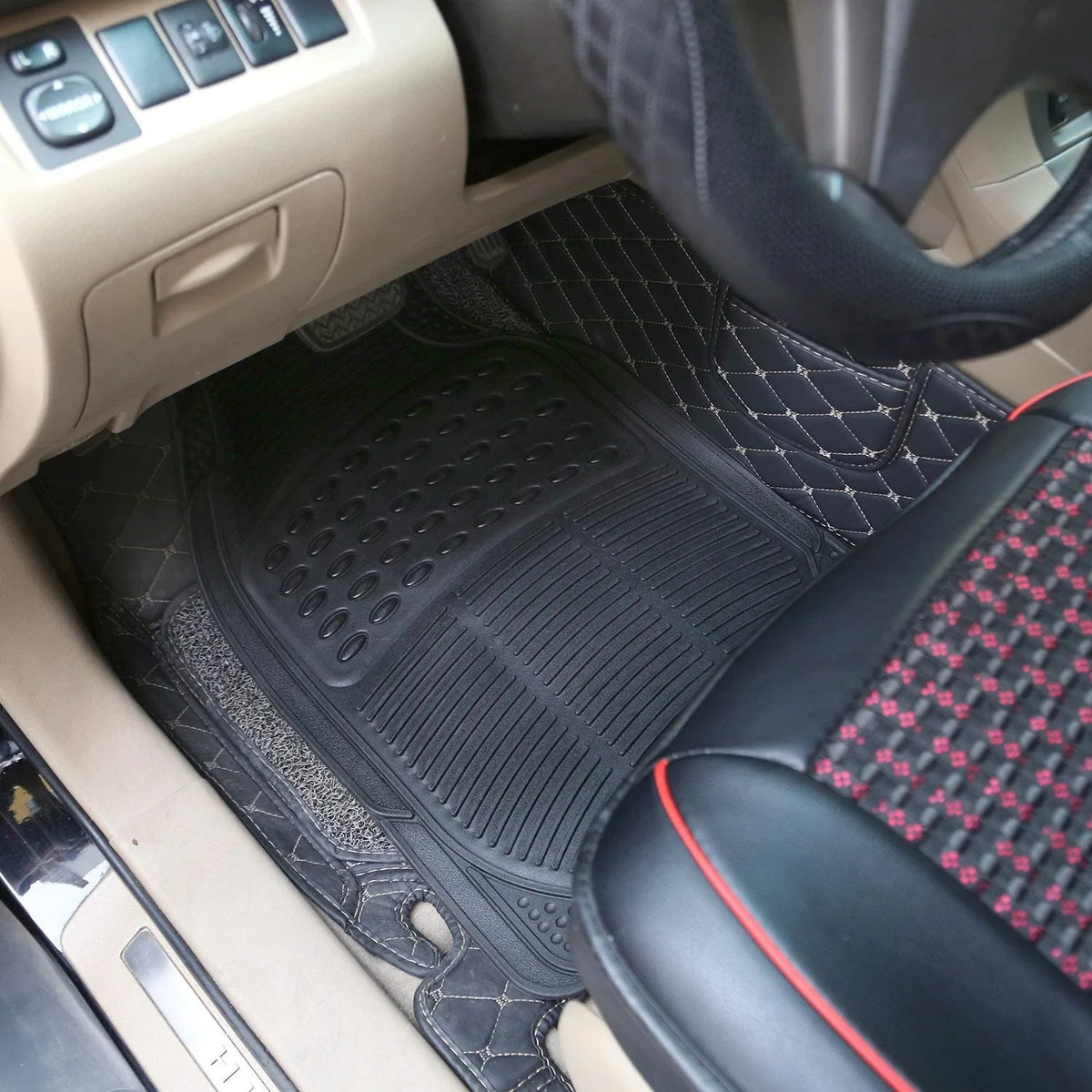 Heavy-duty black rubber car floor mat fitted in the driver's footwell of a car with beige interior