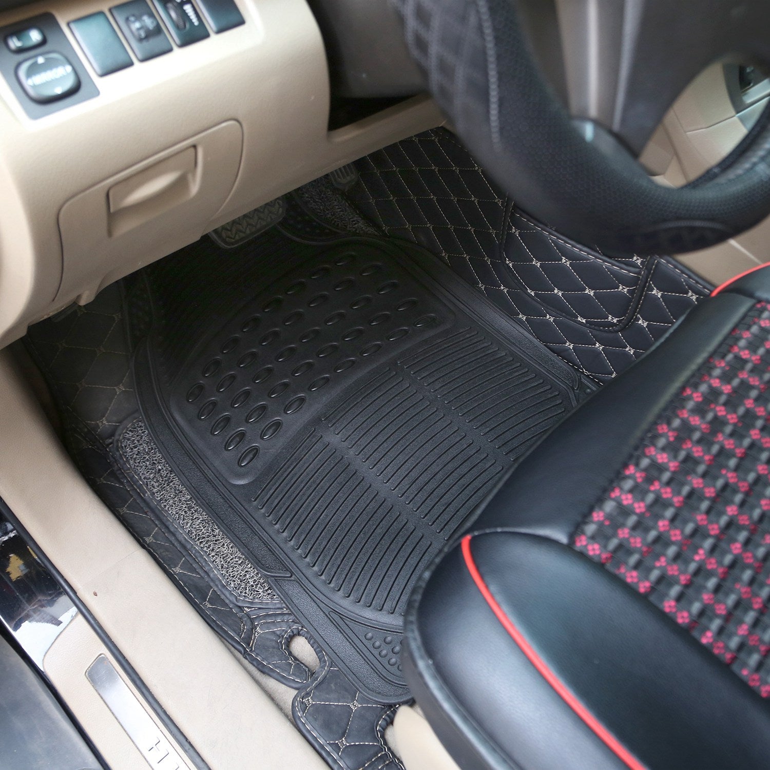Heavy-duty black rubber car floor mat fitted in the driver's footwell of a car with beige interior