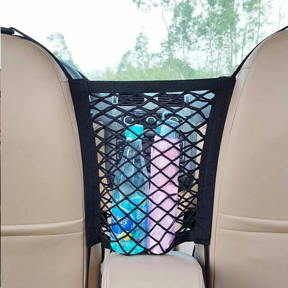Barrier net fitted between two beige car front seats holding drink bottles and a towel