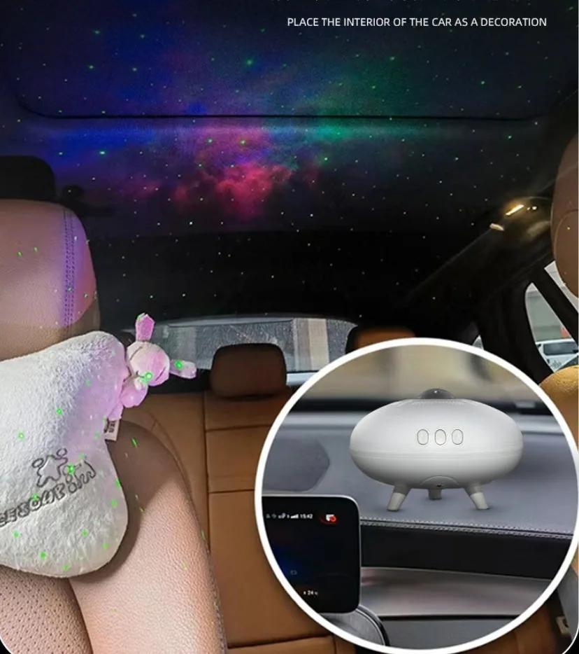 UFO galaxy projector on a car dashboard casting a starry nebula across the car ceiling