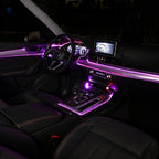 Car interior at night with fiber optic ambient lighting in purple across the dashboard, doors and centre console
