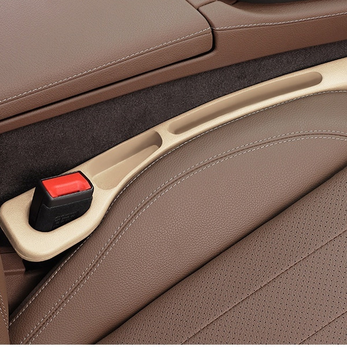 Beige — car seat gap filler strip fitted in the gap beside the seat, seat-belt buckle sitting in the moulded cutout