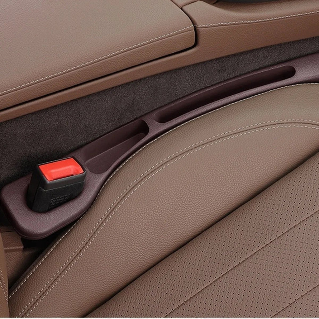 Mocha Brown — car seat gap filler strip fitted in the gap beside the seat, seat-belt buckle sitting in the moulded cutout