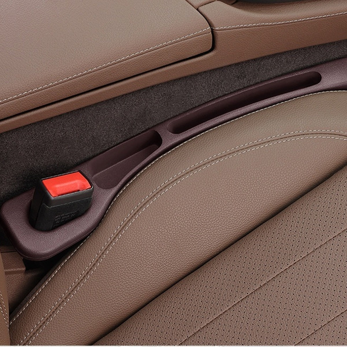 Mocha Brown — car seat gap filler strip fitted in the gap beside the seat, seat-belt buckle sitting in the moulded cutout