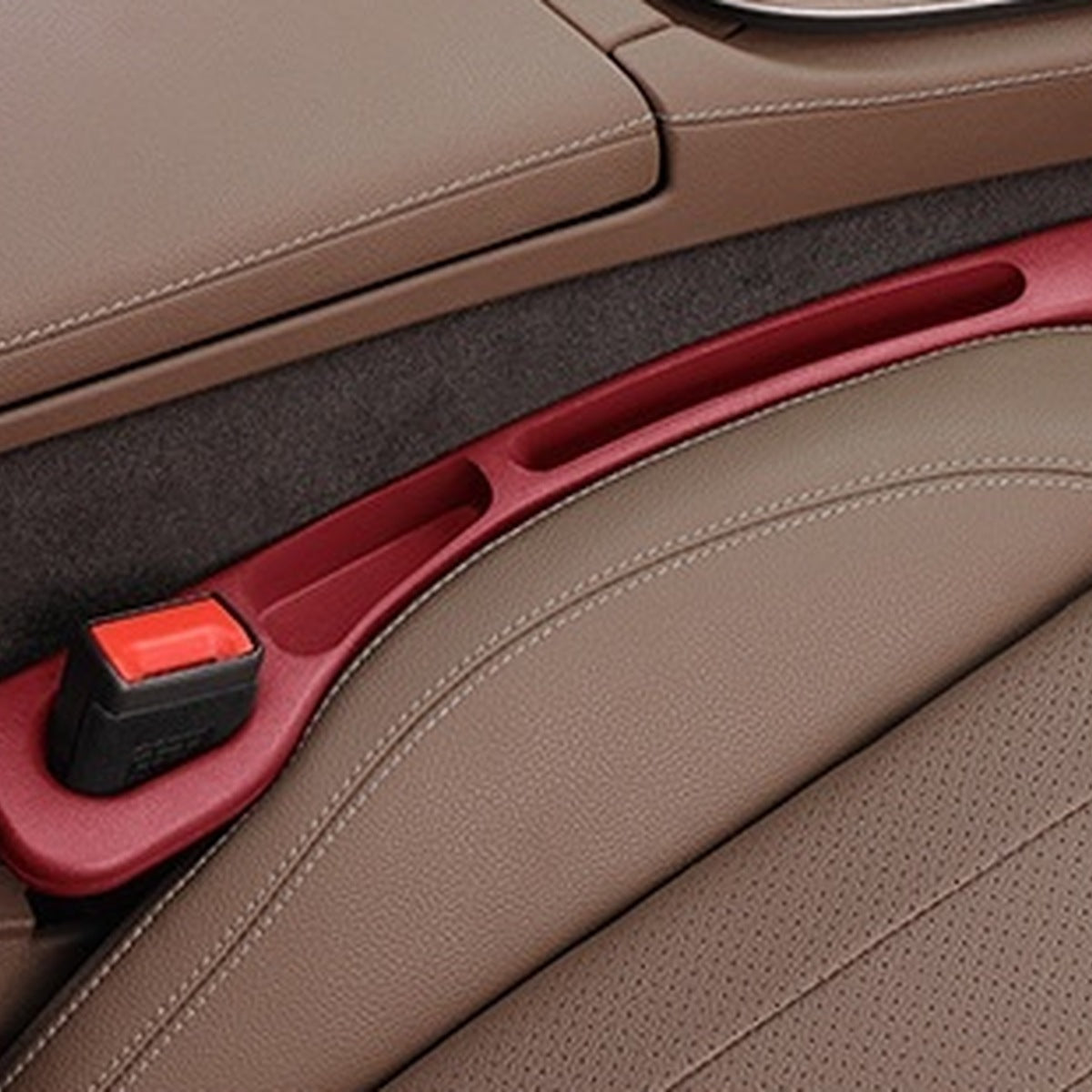 Volcano Red — car seat gap filler strip fitted in the gap beside the seat, seat-belt buckle sitting in the moulded cutout