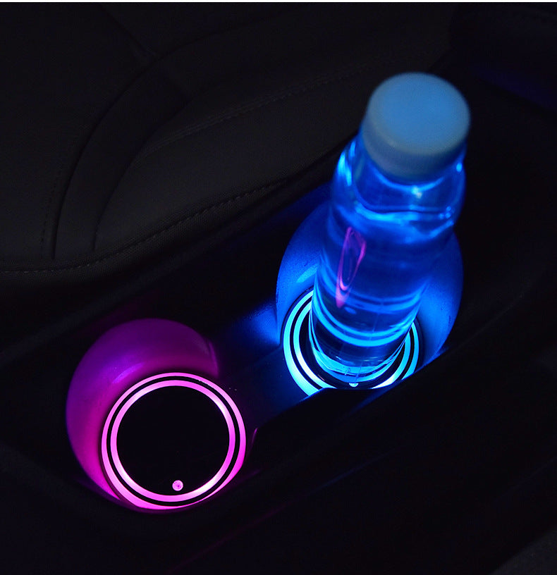 LED Car Cup Holder Mat in use — lit coasters under a water bottle in the console cup holders