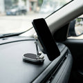 Magnetic car phone mount holding a phone on a car dashboard