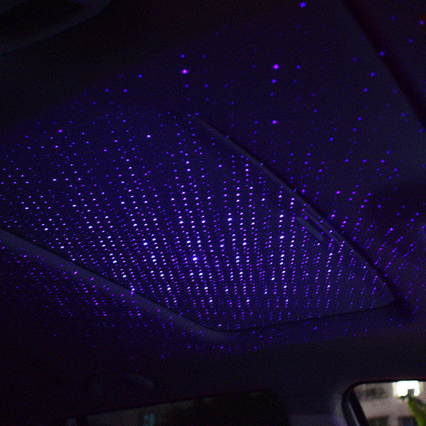 Car interior lighting bundle — the USB star projector casting a field of violet stars across a car headliner at night