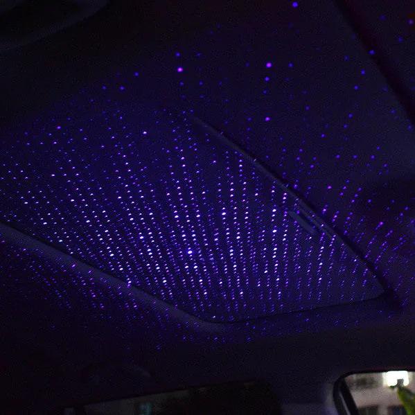 Car interior lighting bundle — the USB star projector casting a field of violet stars across a car headliner at night