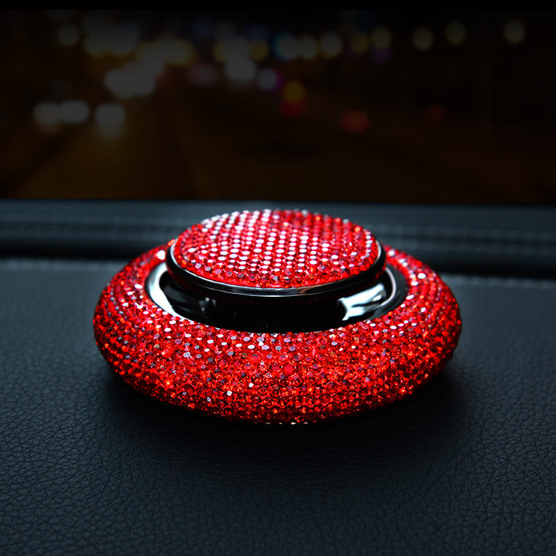 Crystal Car Air Freshener in use — red rhinestone unit sitting on a leather dashboard at night
