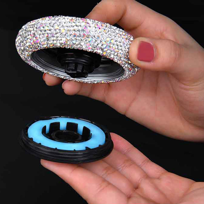 Crystal Car Air Freshener in use — hand unscrewing the white unit to show the refillable balm base