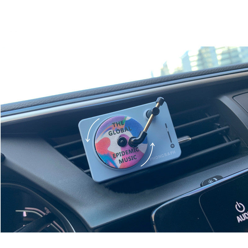 Record Player Car Vent Diffuser in use — blue unit clipped to a dashboard air vent