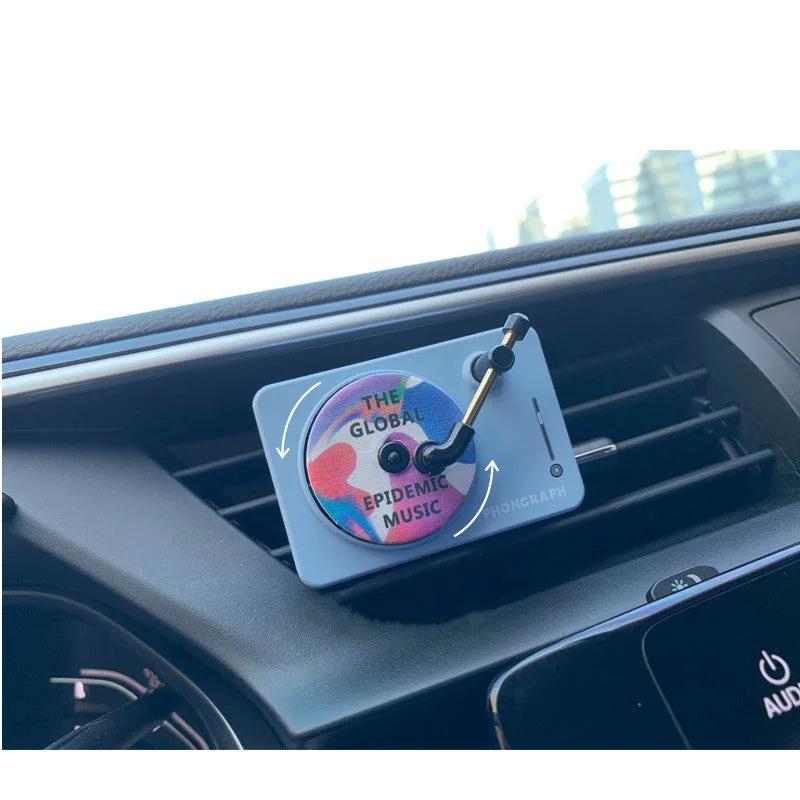 Record Player Car Vent Diffuser in use — blue unit clipped to a dashboard air vent