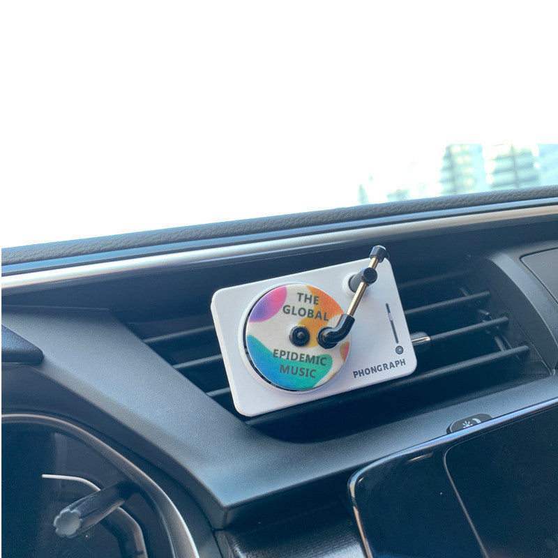 Record Player Car Vent Diffuser in use — white unit clipped to a dashboard air vent