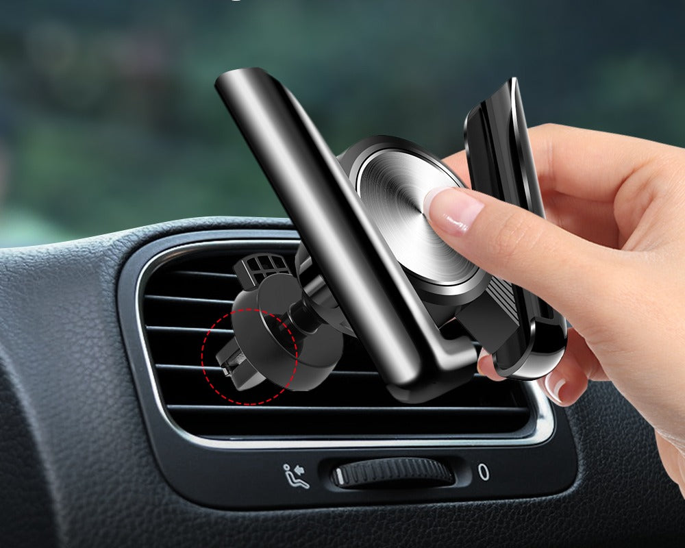 A hand clipping the phone mount onto a car air vent
